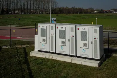 Drie witte batterijcontainers van Vyon Energy opgesteld naast een bedrijfsterrein.